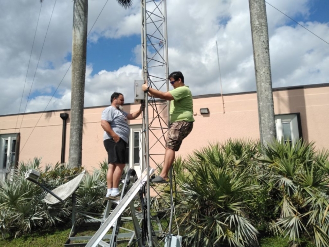 Robert KE4MCL and Alain K4KKC attaching the APRS System to the tower.